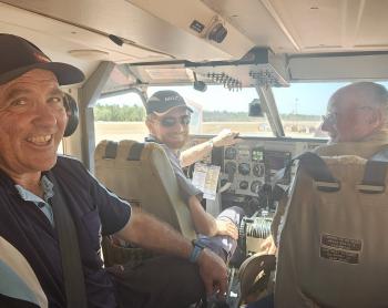 Three men inside light aricraft