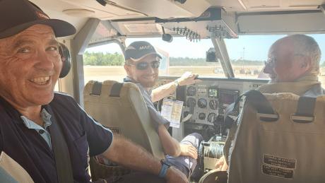 Three men inside light aricraft