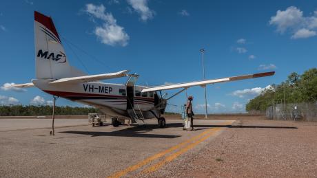 Cessna caravan on concrete tarmac in bright sunlight 