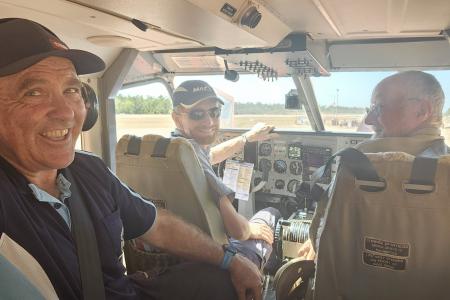 Three men inside light aricraft