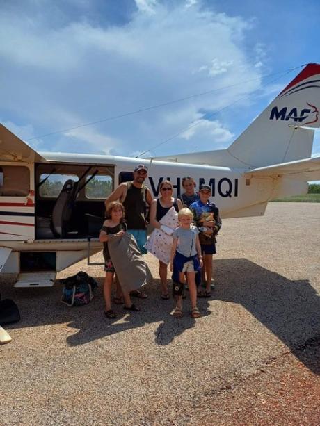 Family standing in front of aeroplane