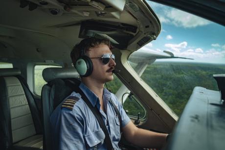 Pilot flying Cessna C208, interior shot