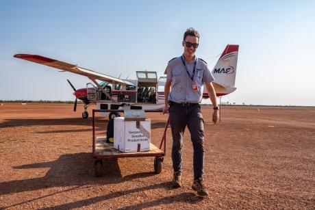 MAF Pilot unloading plane