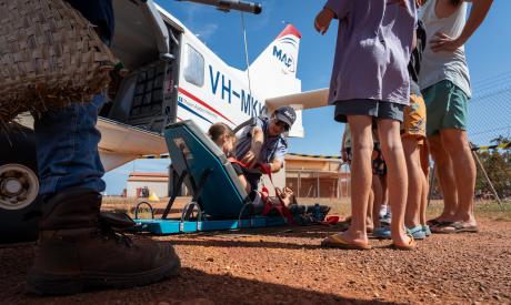 Pilot demonstrating olperation of stretcher lift on GA8 aircraft