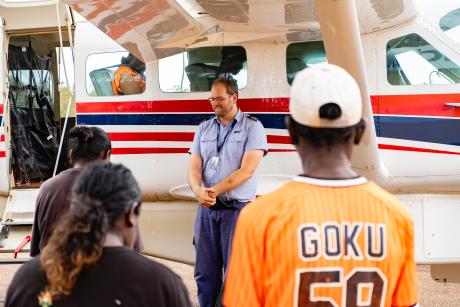 Pilot and passengers praying before boarding aircraft