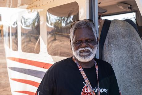 Yolngu man standing at aircraft door