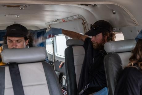 Nurse fanning patient on aircraft in flight