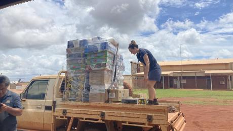 staff unlolading supplies from vehicle