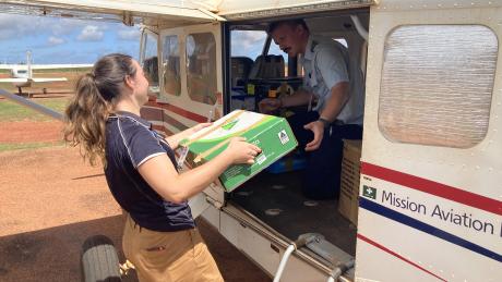 woman loading supplies onto aircraft