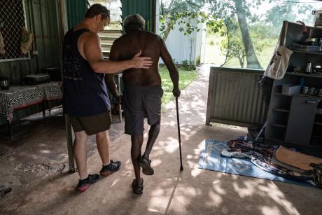 physiotherapist supporting patient with walking