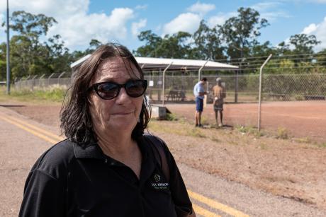Woman looking into camera on airport tarmac