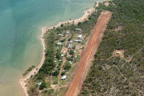 aerial view of a small community of houses by a beach