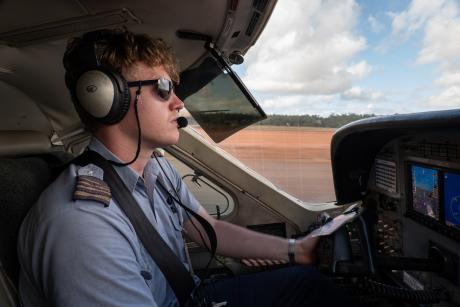 Pilot in cockpit landing plane with motion blur